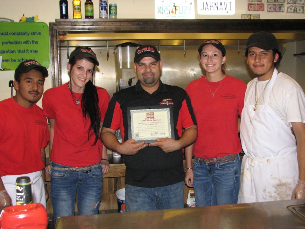 staff The friendly staff at Foster's Grille on Southern Blvd. in Royal Palm Beach. The Manager Axel (middle) holds their certificate for "Best Burger of the Palm Beaches," as voted on by our Around Wellington readers.
